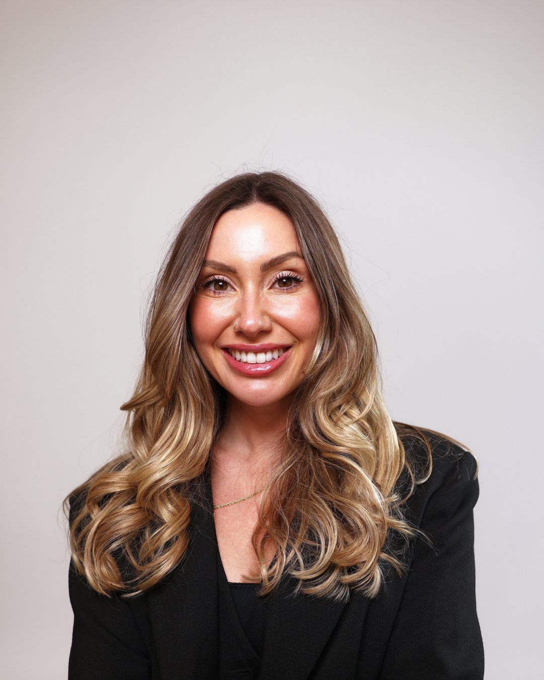 Lucy Scarlett, smiling, in a black blazer